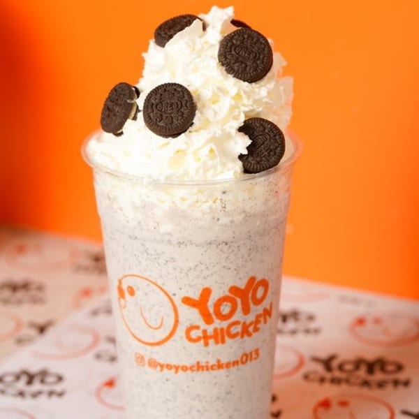 Oreo milkshake with whipped cream and Oreo cookies on top, with a Yoyo Chicken logo.