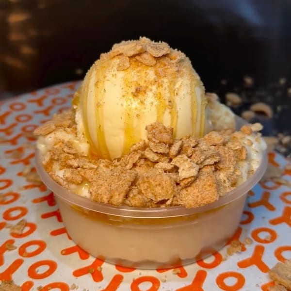 Yoyo Chicken's vanilla ice cream with honey drizzle and crunchy cereal topping in a clear cup.